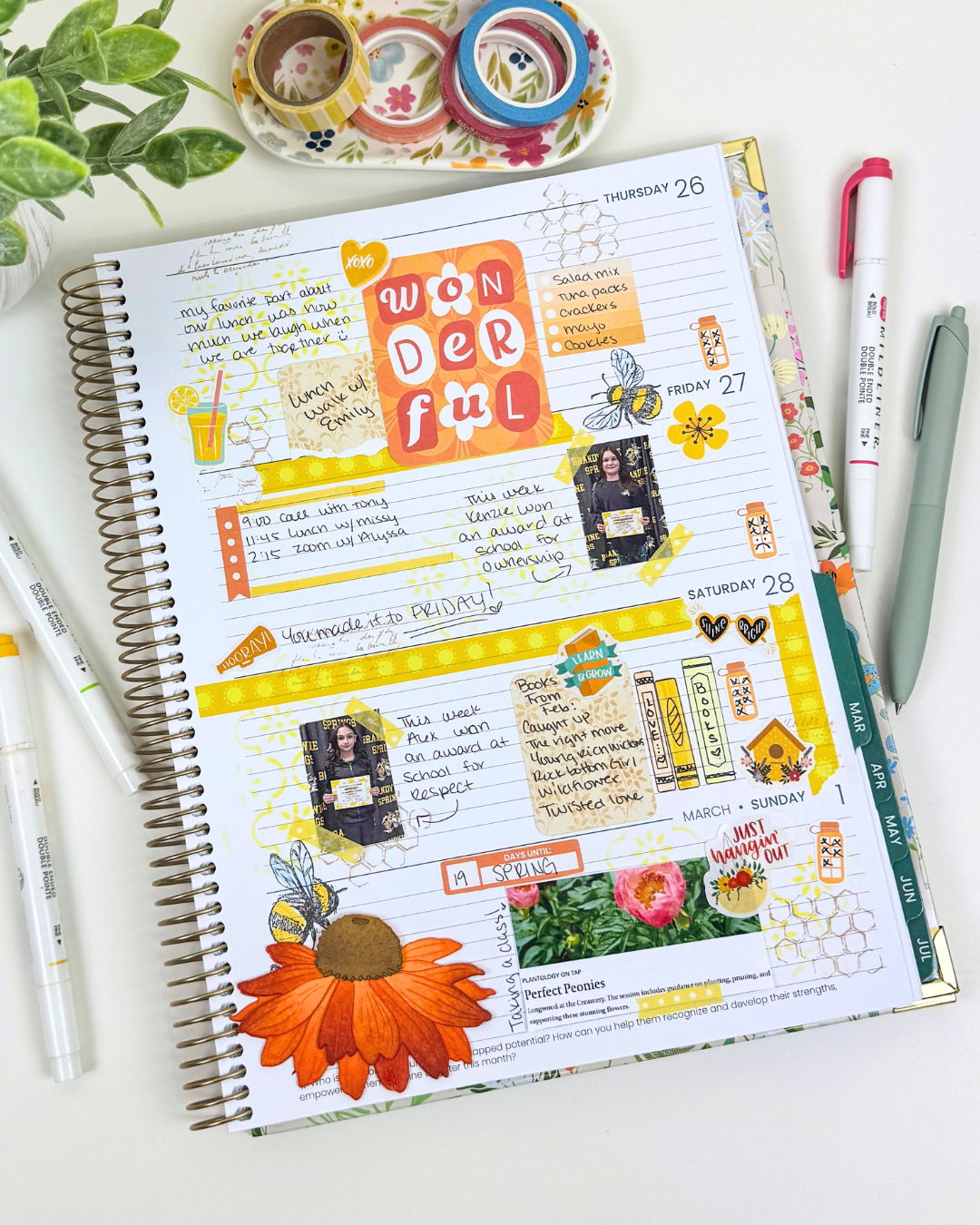 A planner page with scrapbook style photos and notes in orange and yellow tones.