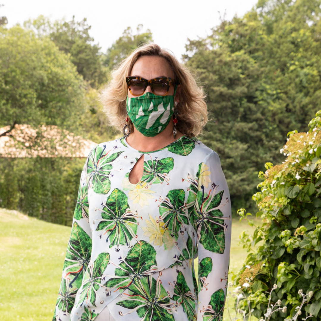 Ala Isham wearing printed silk blouse with printed mask at her house in Newport Rhode Island