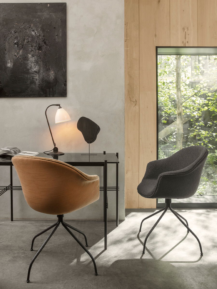 Two Bat Office Chairs by Gubi in a stylish interior with natural light.