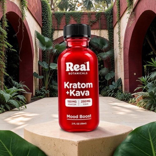 Red bottle of Kratom + Kava on a wooden pedestal in a green setting.