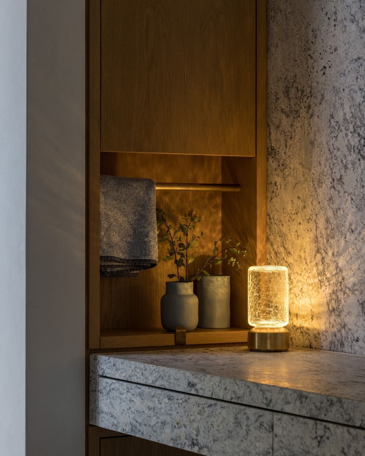 Glass portable table lamp styled on a luxury bathroom counter