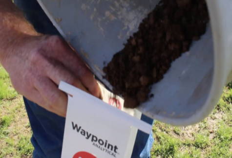 pouring soil from a bucket into a soil sample bag