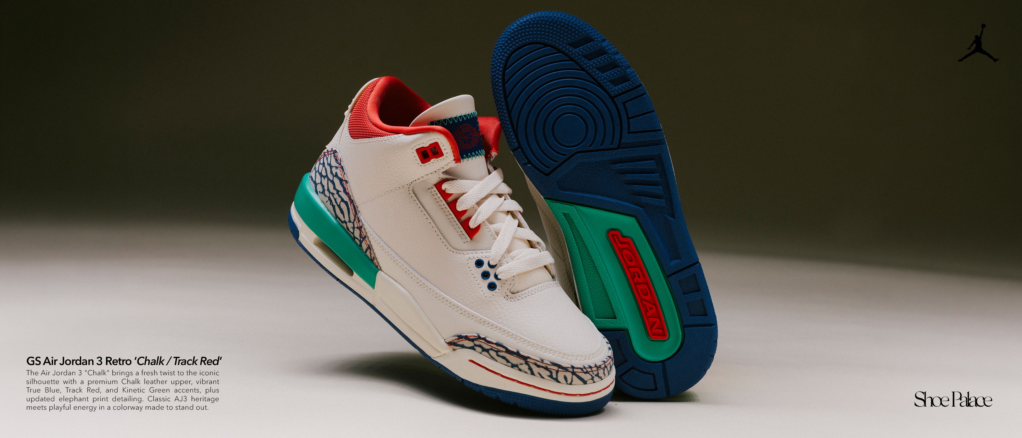 White and colorful sneakers with a blue sole on a dark background.