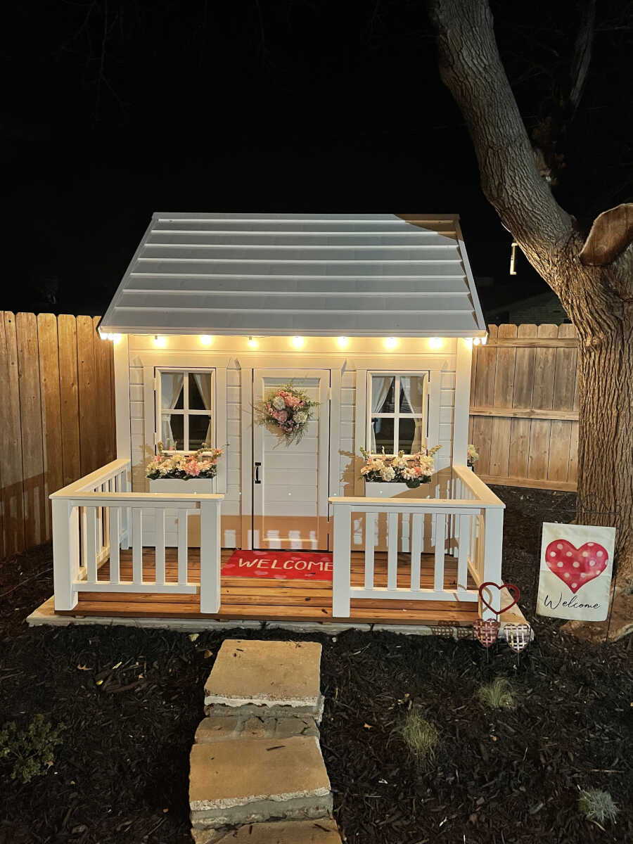 White Outdoor Playhouse with white Flower boxes and  in a backyard by WholeWoodPlayhouses