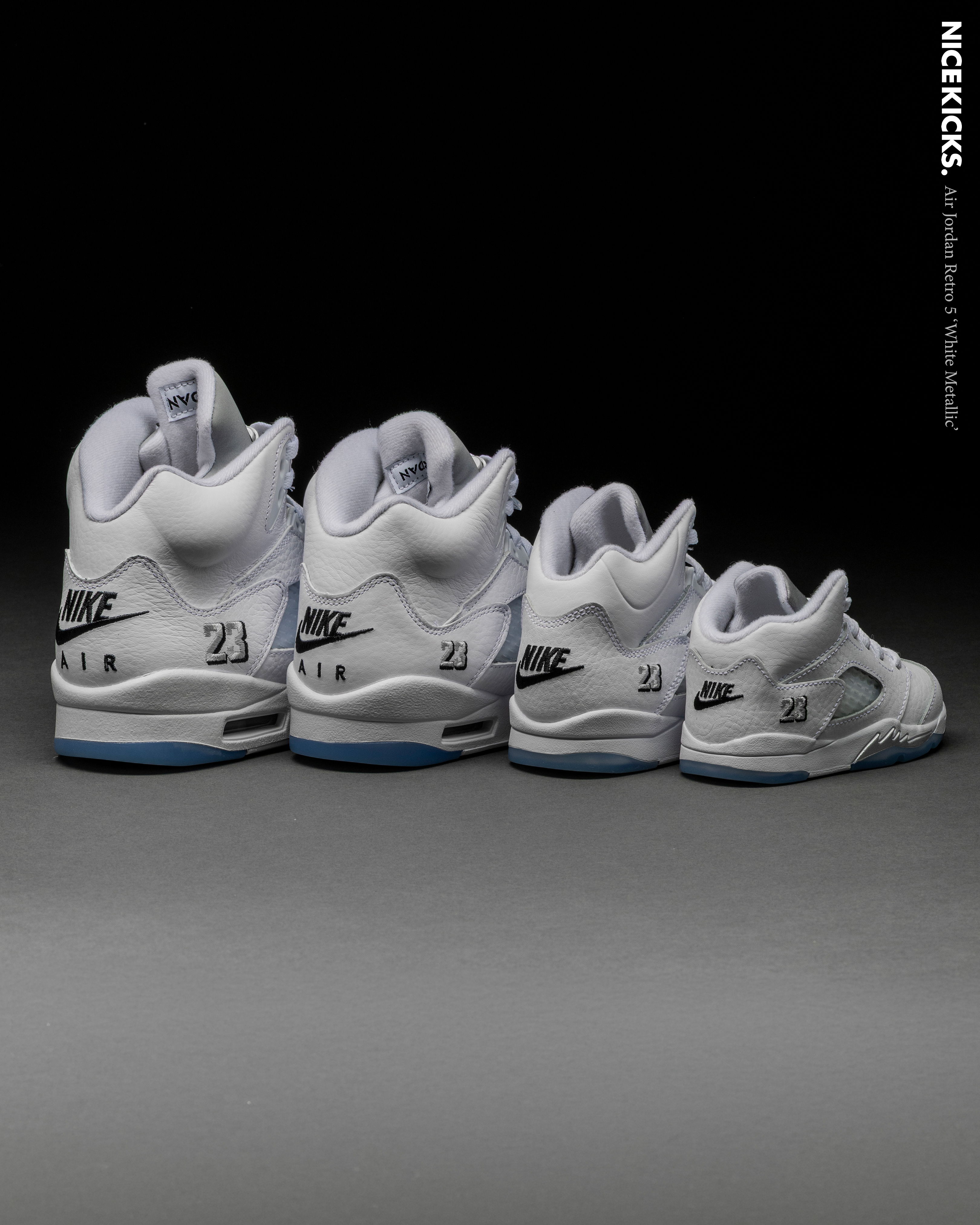 Four pairs of white sneakers lined up from largest to smallest.