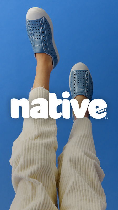 Person's legs wearing blue shoes against a blue background with 