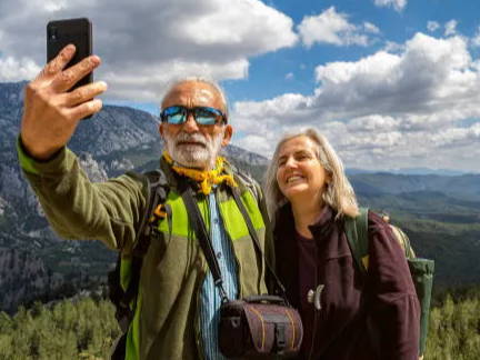 Senior couple taking a selfie in mountains
