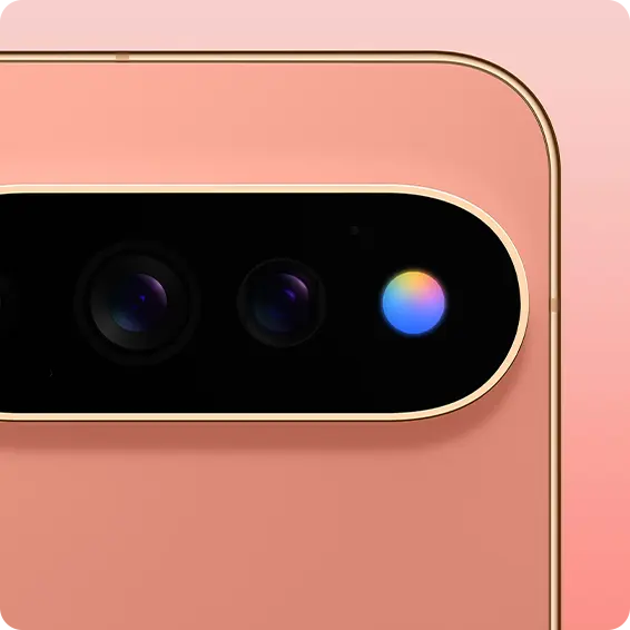 Close-up of a smartphone camera lens with a pink background.