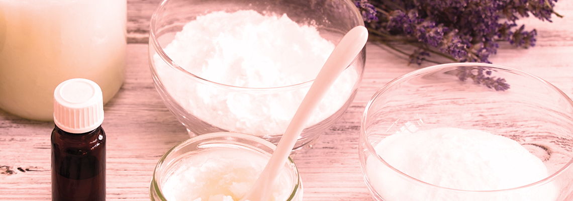 Bottles and bowls with ingredients, including lavender and various powders.