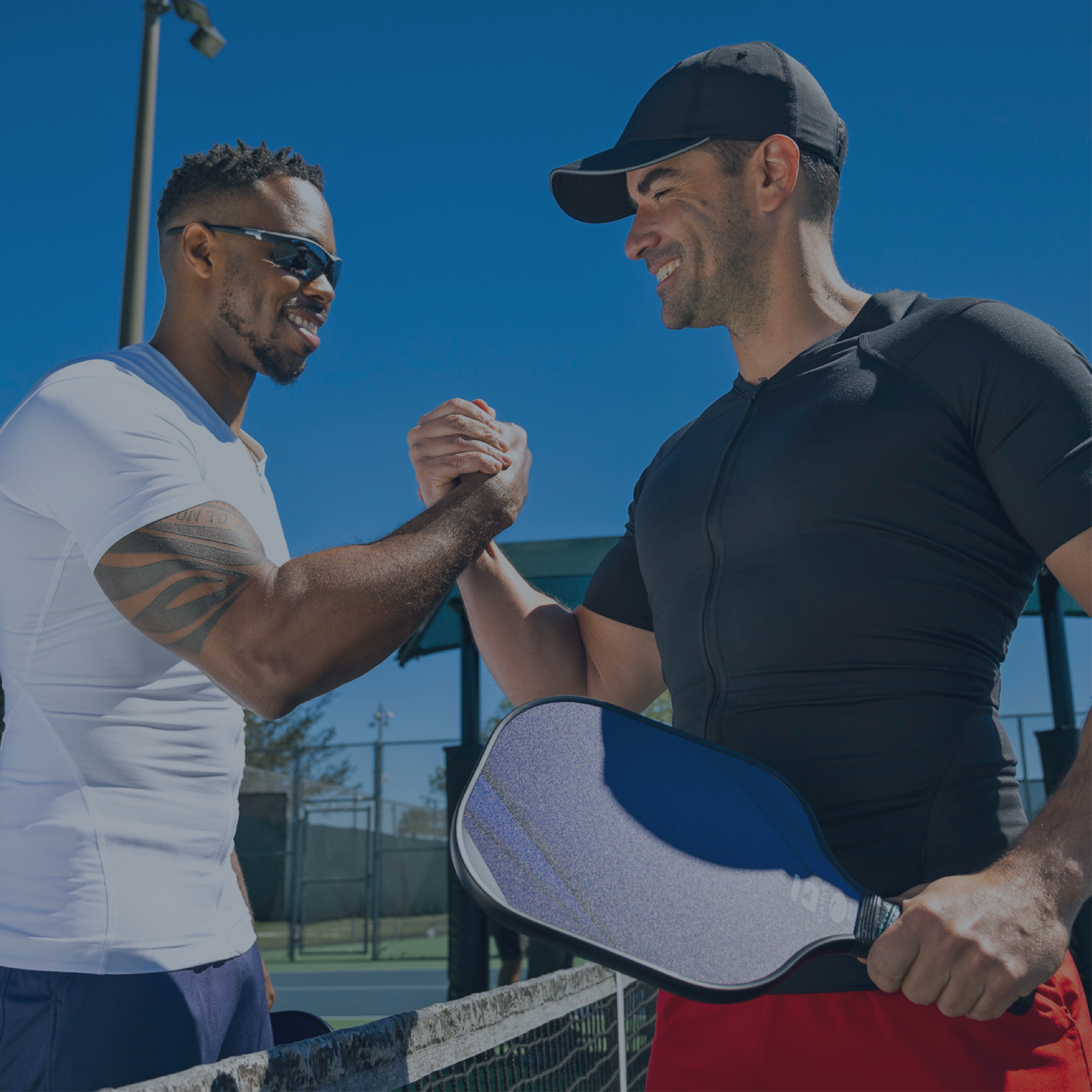 Two men wearing Full Back Support Shirts playing pickleball