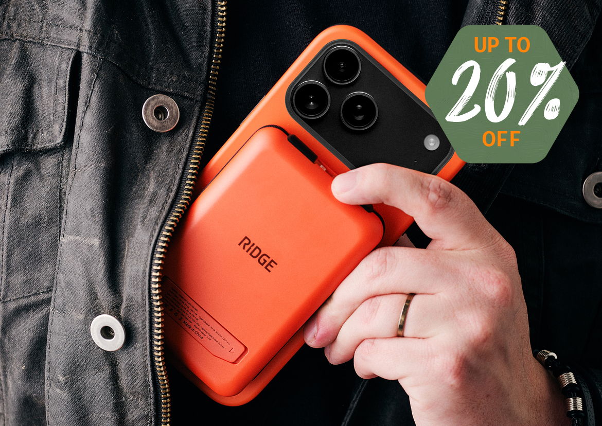 Person holding an orange phone case with a discount tag.