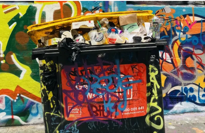 Dumpster filled with plastic trash