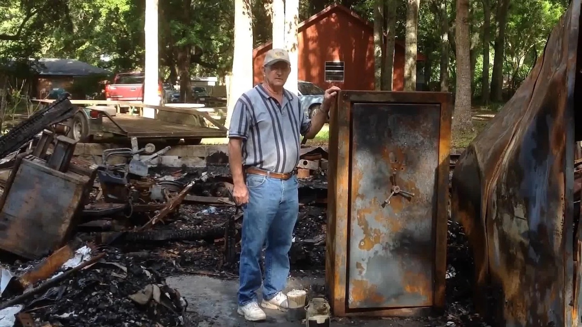 man with a safe after surviving a fire