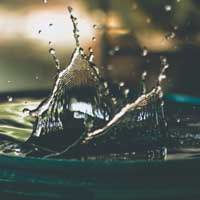 Water droplets bouncing off a rain barrel