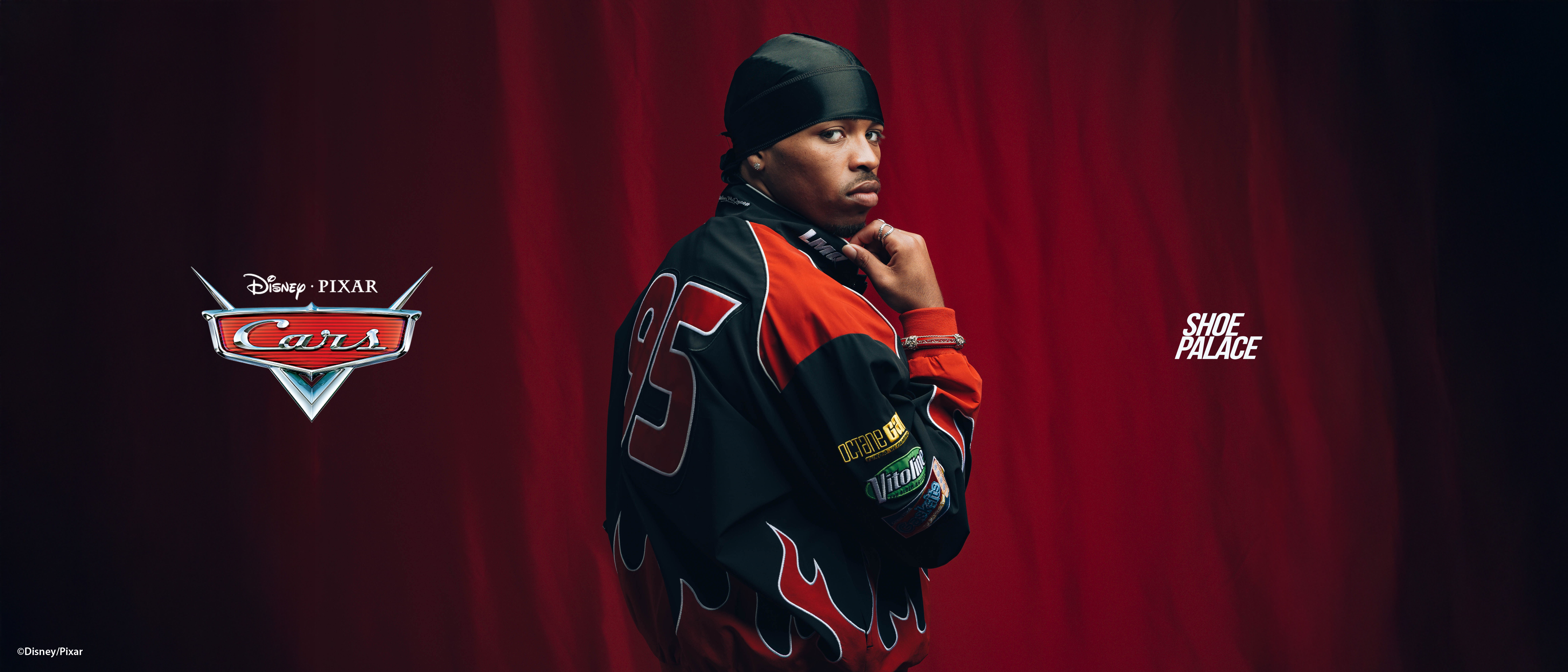 Person in a red and black jacket against a red background.