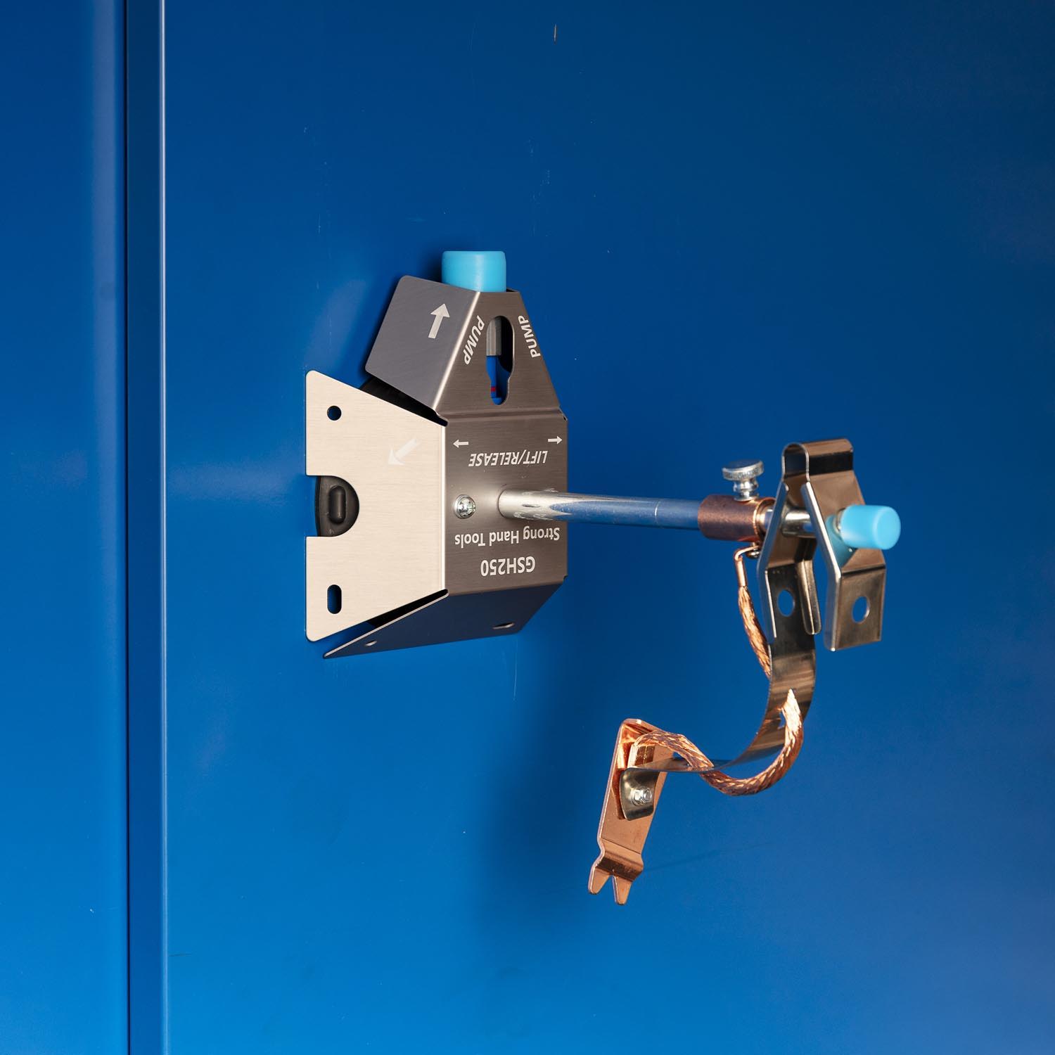 A blue electrical device mounted on a blue wall.