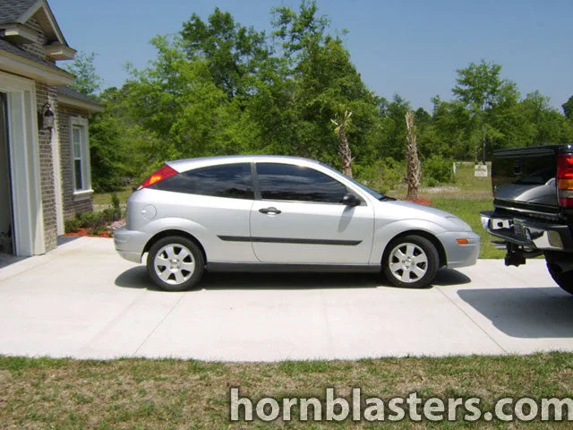 Exterior three-quarter view of Layne's 2002 Ford Focus with HornBlasters Shocker XL train horns featured customer install gallery photo 1