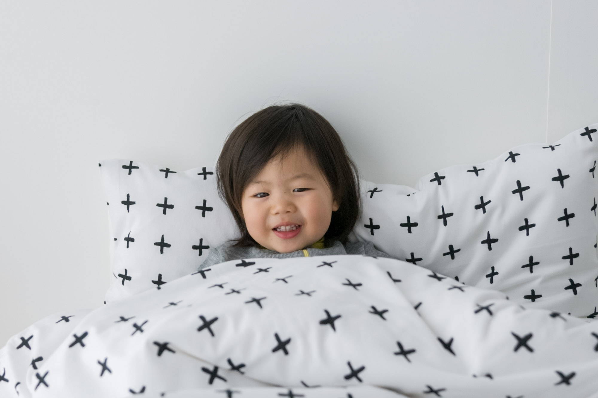 Image of toddler in a big kid bed