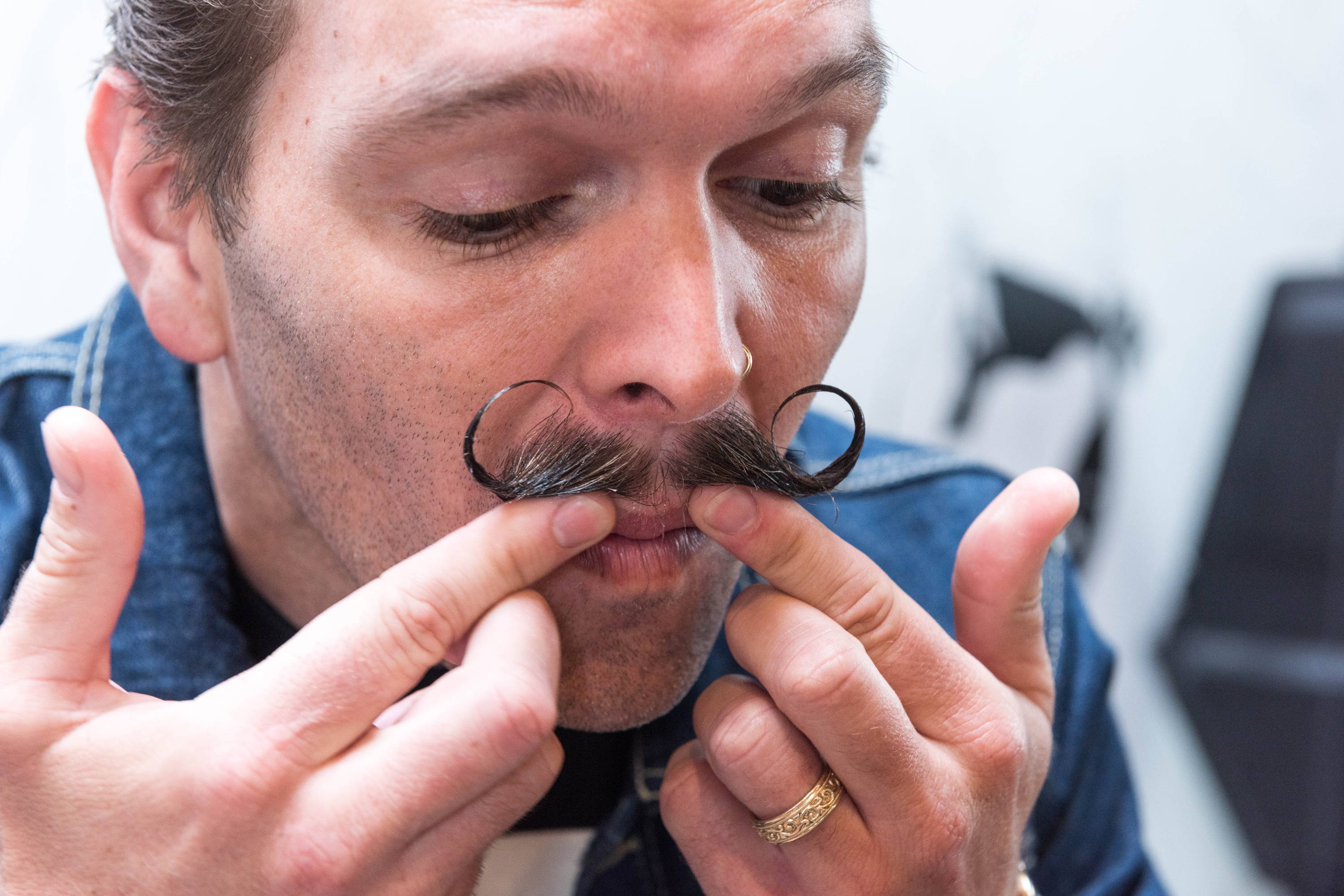 man styling his mustache