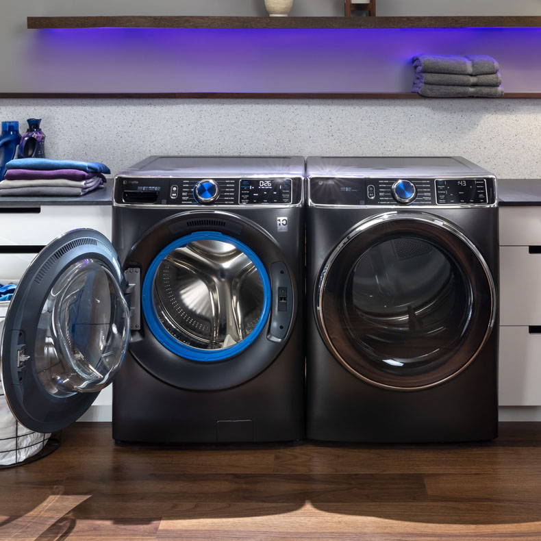 GE Profile Front Load washer and dryer in laundry room, with door open