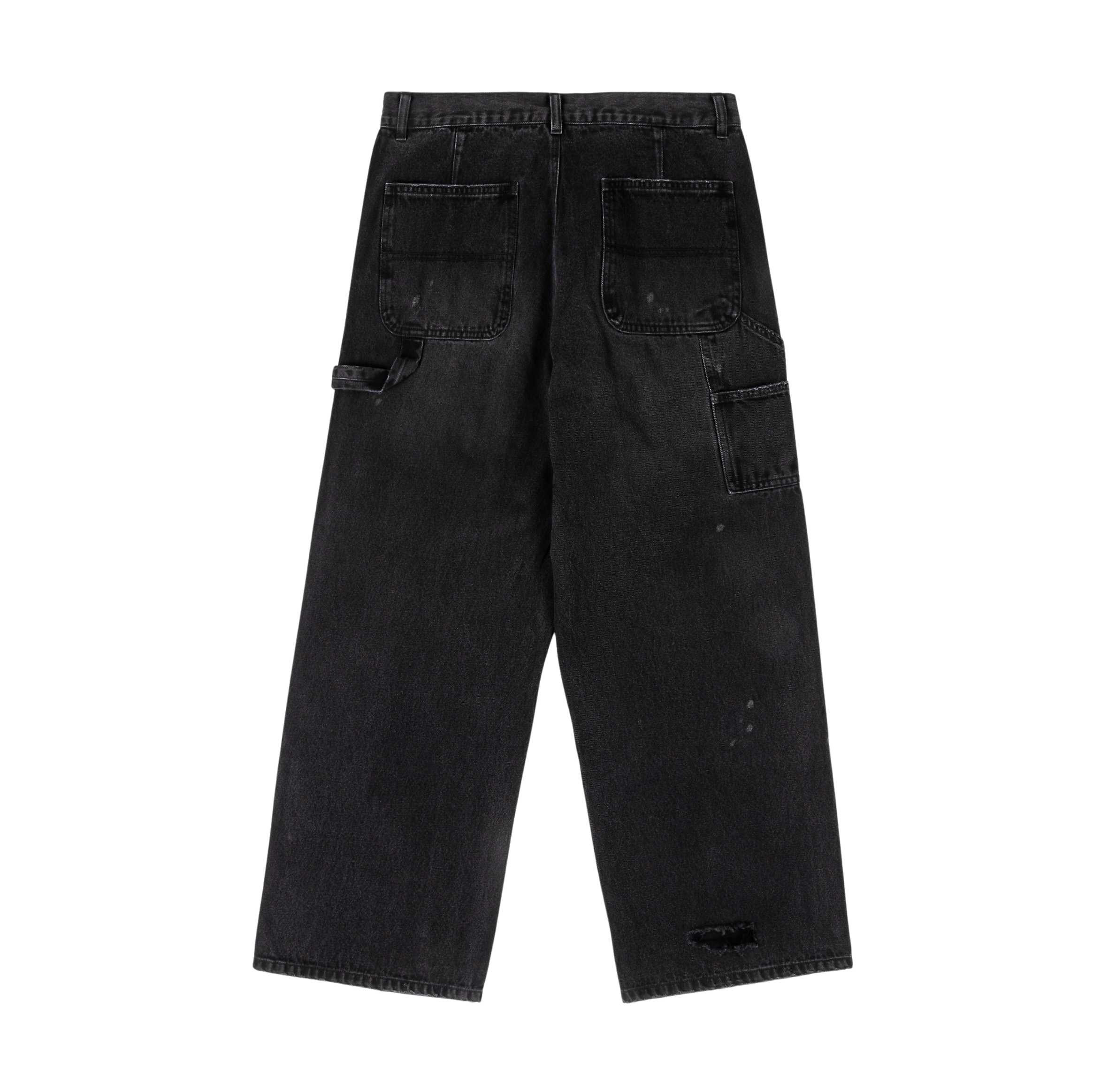 Black baggy jeans with various patches and distressed details.