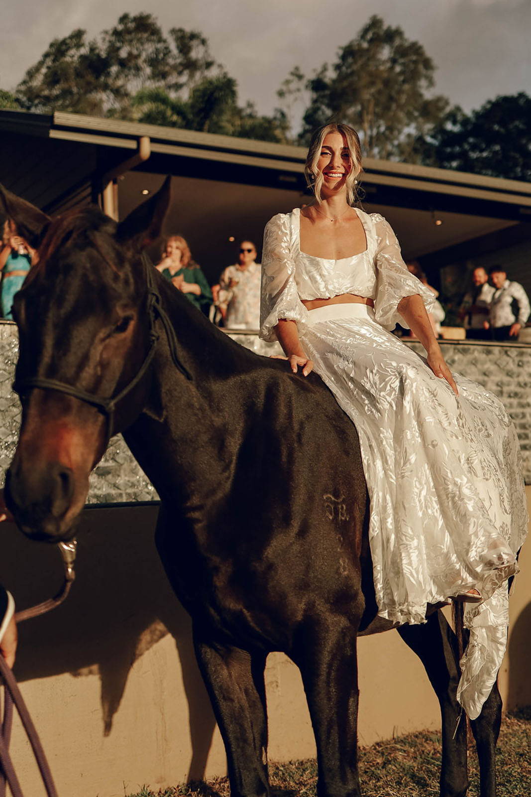 Bride on horse at farm wedding