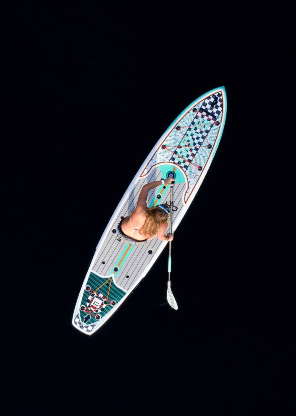 Overhead view of a woman paddling the HD Bug Slinger Echo
