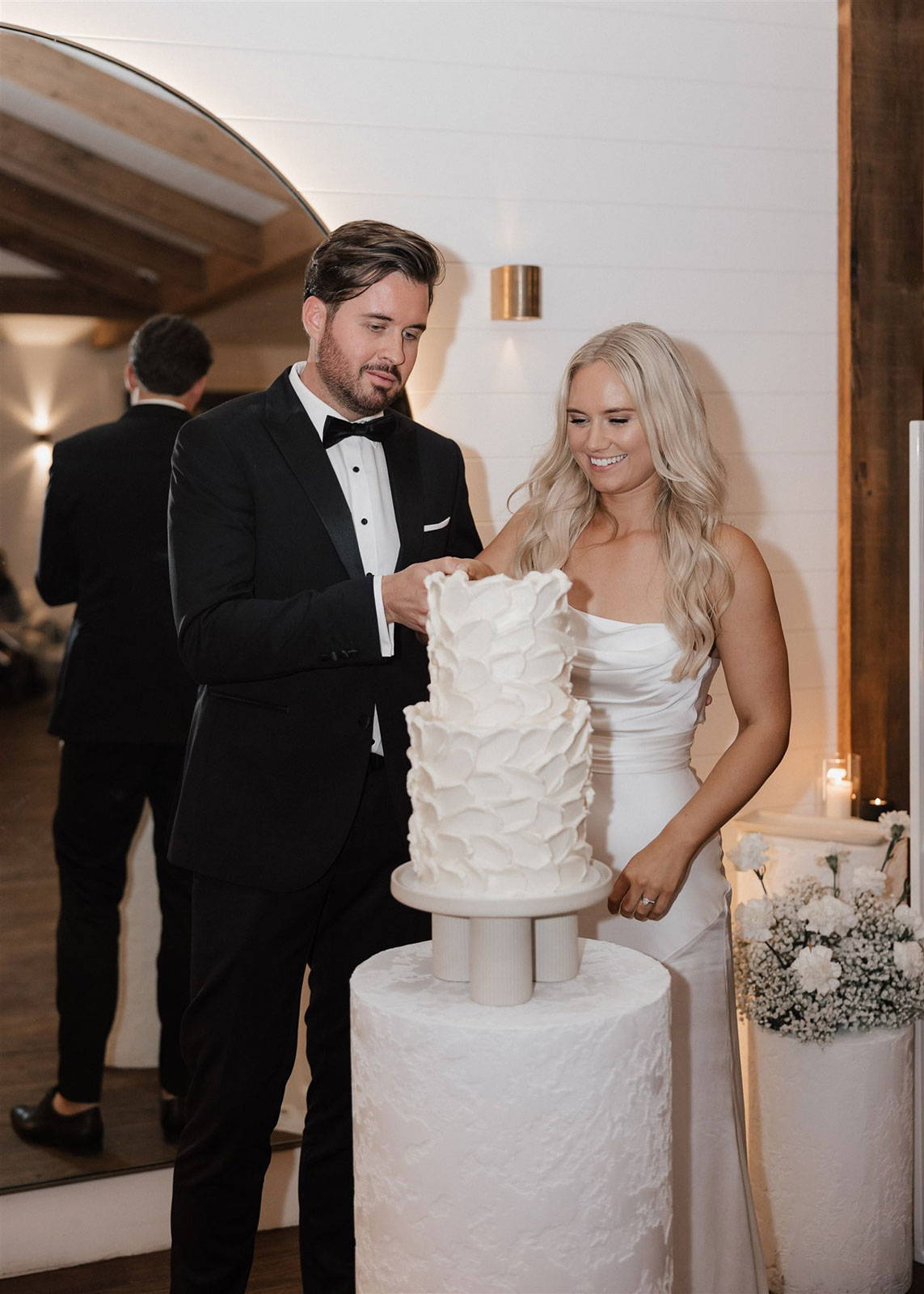 Bride and groom cutting wedding cake