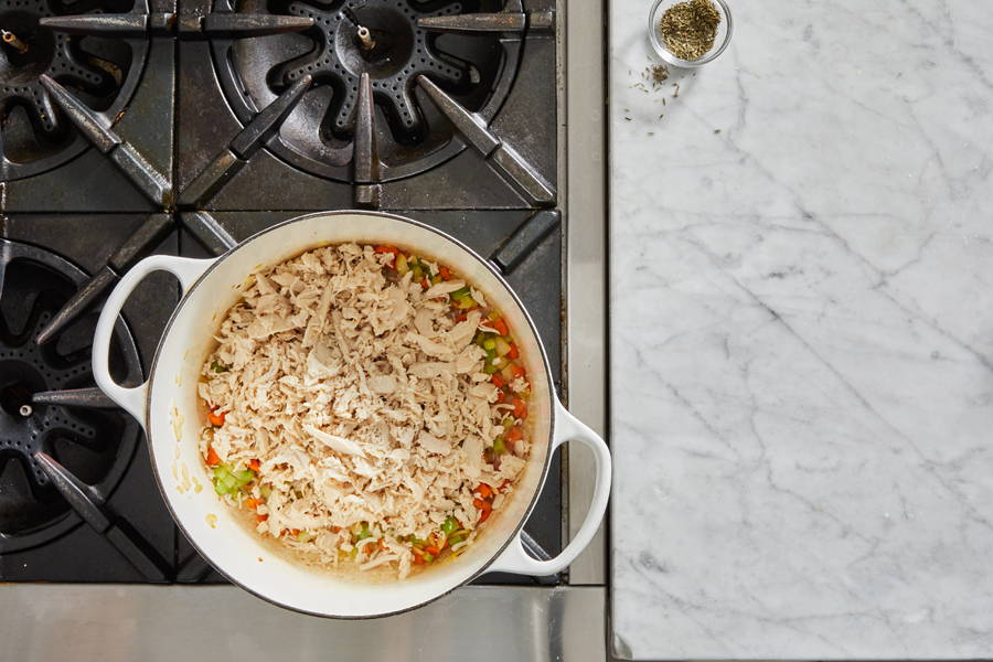 Shredded chicken added to the pot