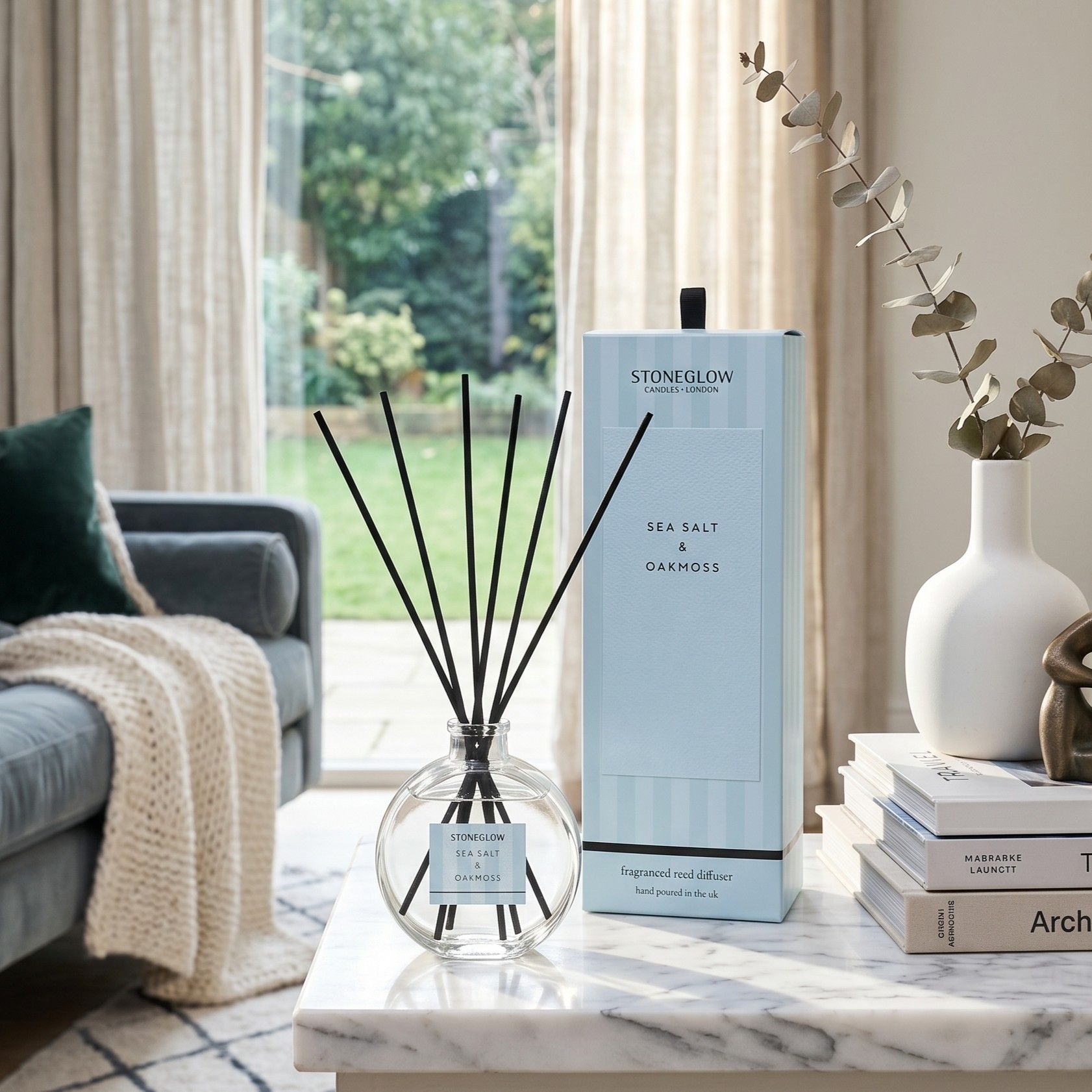 A stylish room with a diffuser and decorative items on a table.