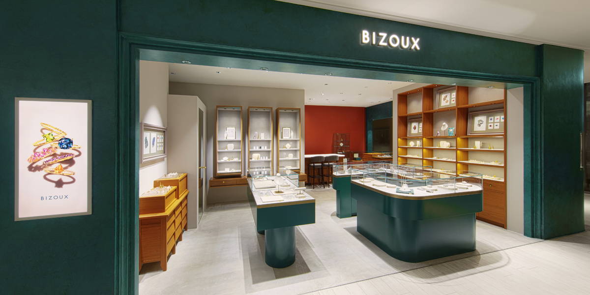 Store interior with displays, counters, and the sign “BIZOUK”.