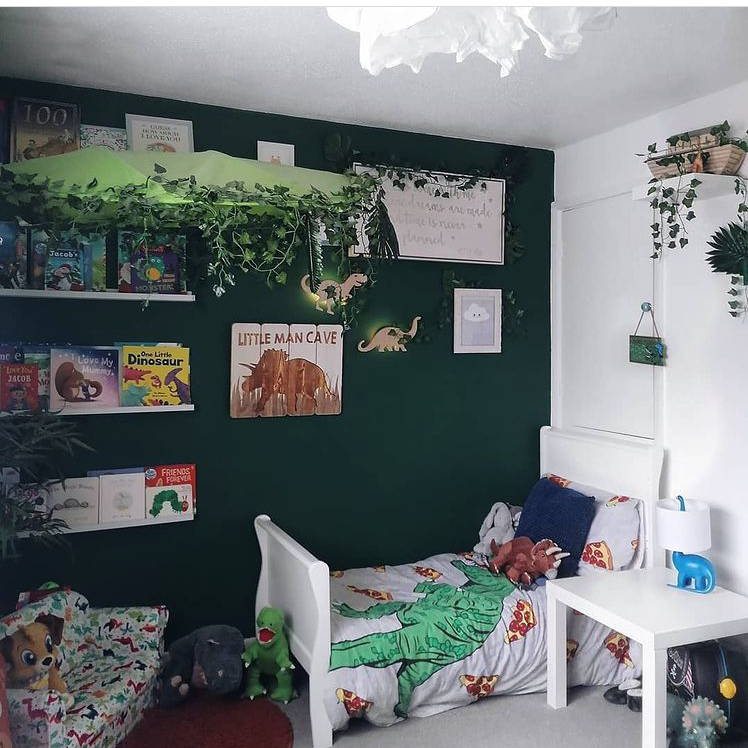 Dinosaur themed children's bedroom with dinosaur wall lights illuminated on wall