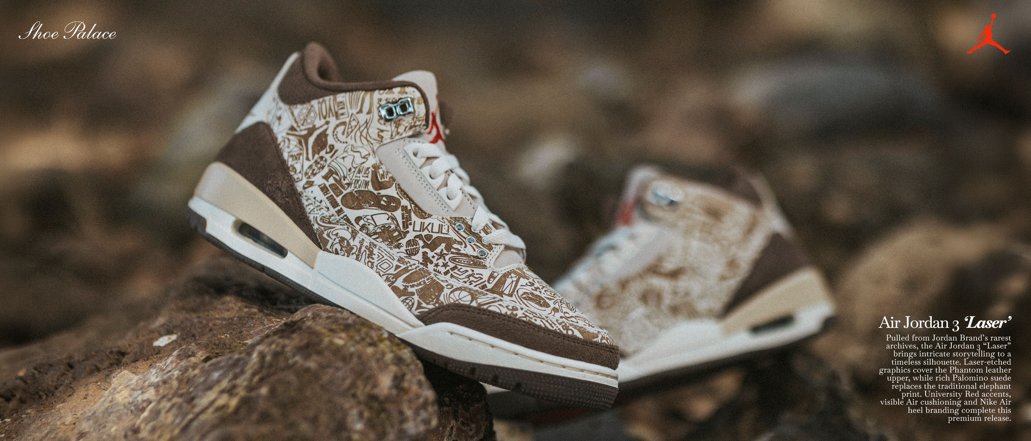 A pair of stylish sneakers placed on rocky terrain.