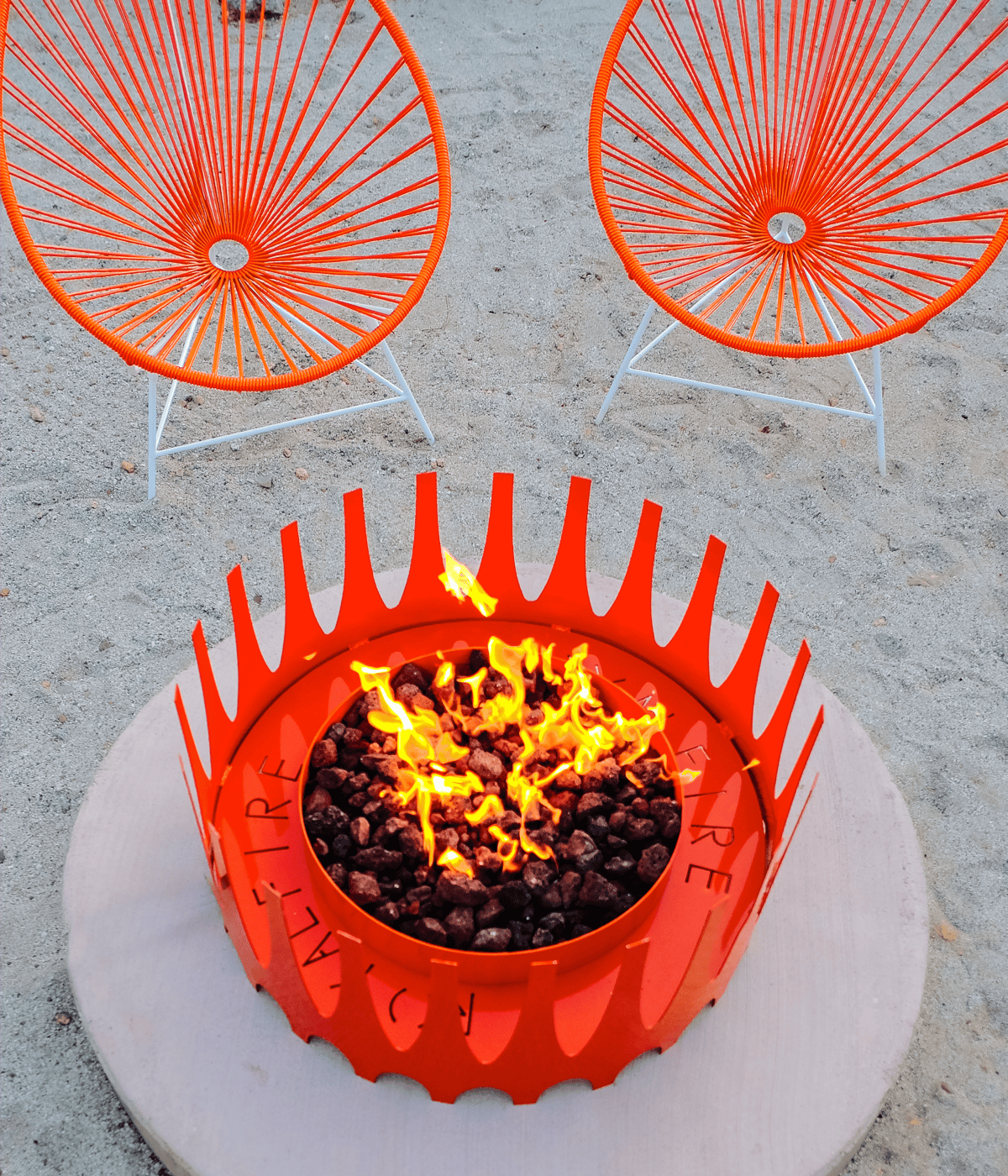 Boxhill's royal fire pit in bright orange flames paired with matching Acapulco lounge chair on a desert patio.