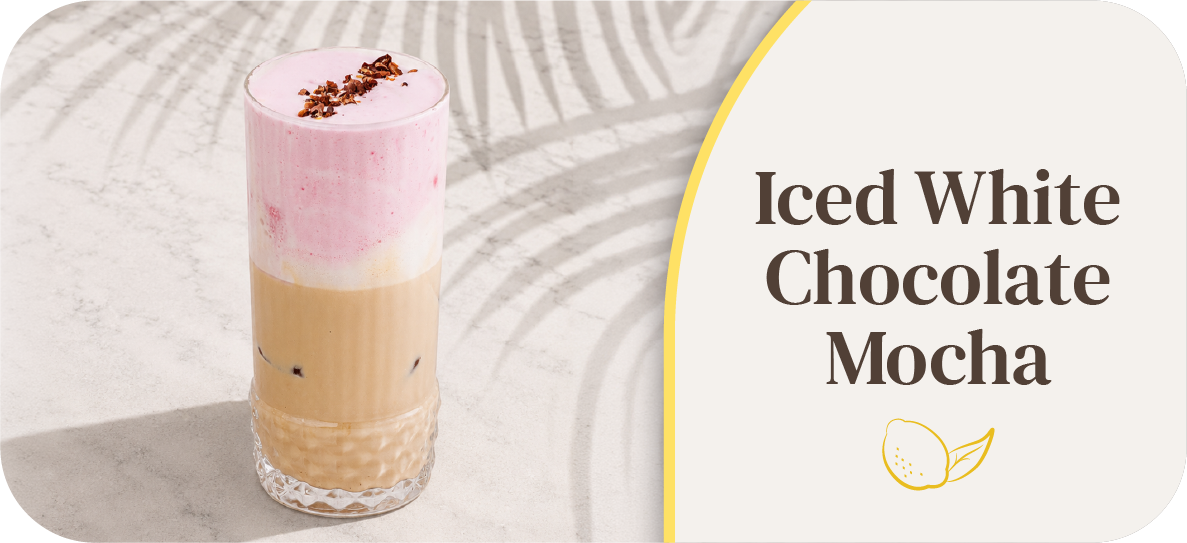 Iced White Chocolate Mocha in a tall glass with pink foam.