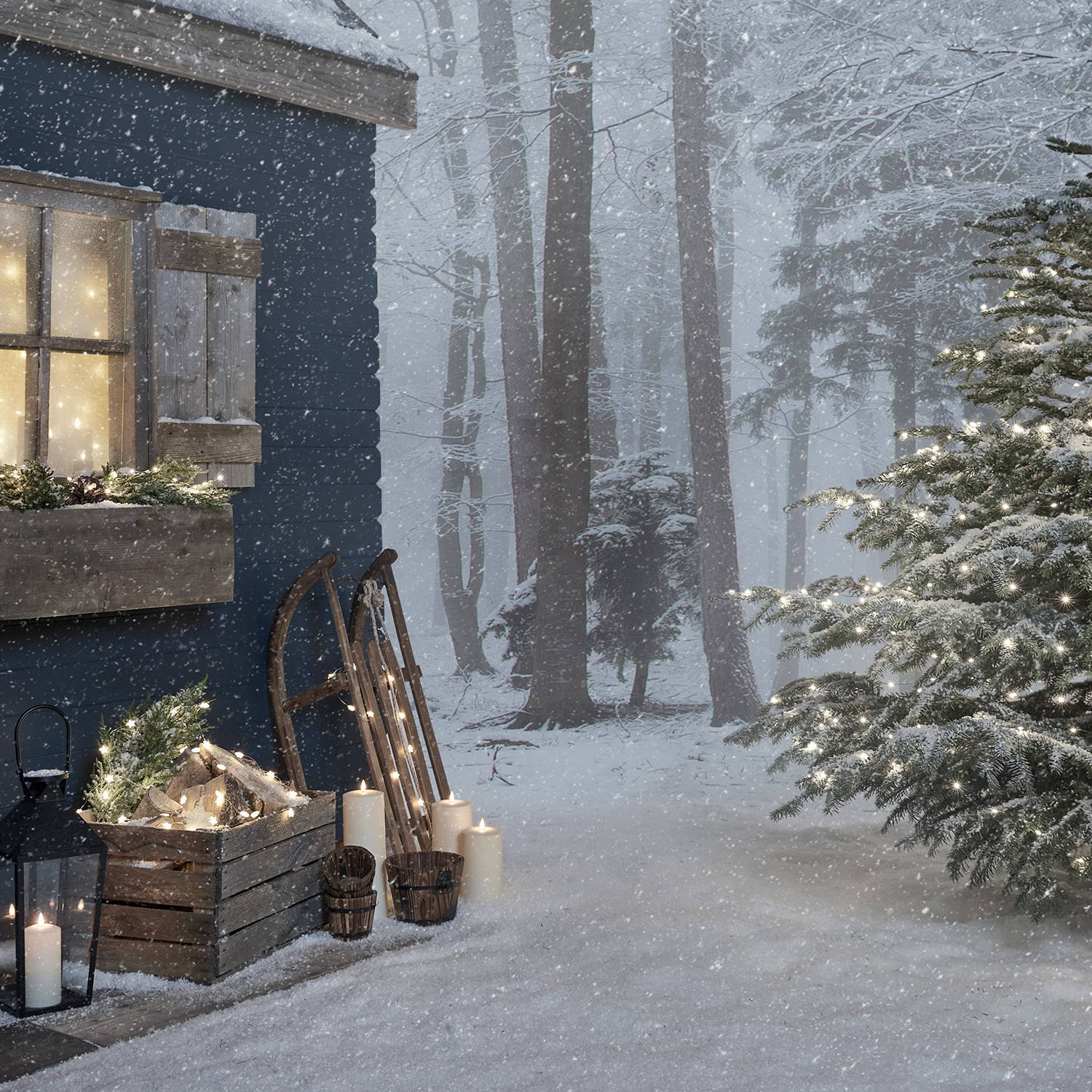 Front of cabin with artificial garland, candles, lantern and fairy lights.