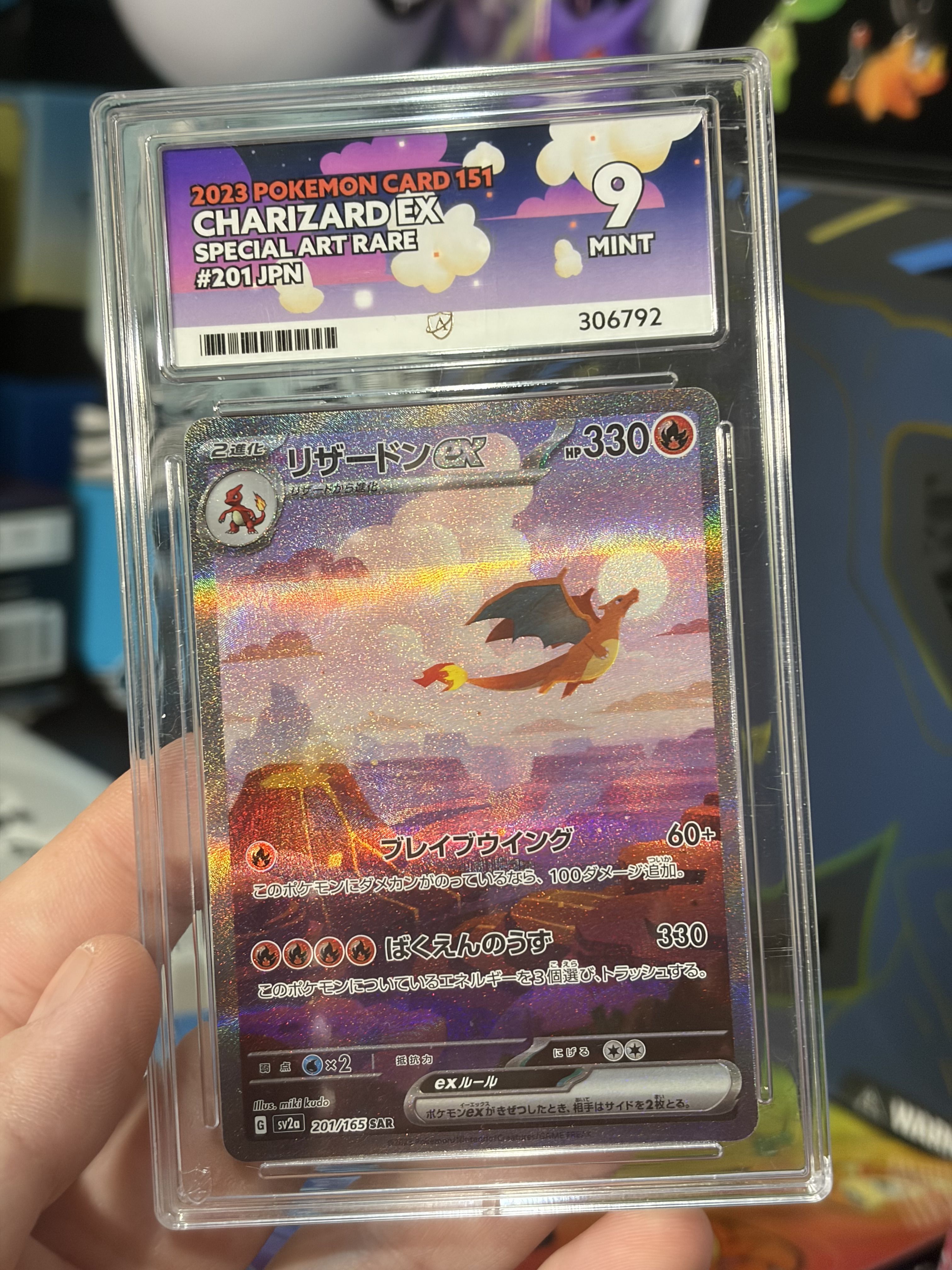 Charizard Pokémon card in protective case, featuring vibrant artwork and grading information.