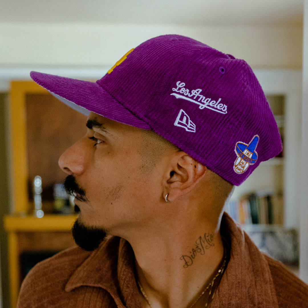 man wearing purple dodgers hat