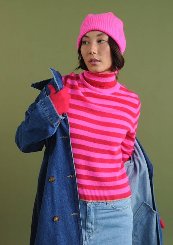 A model wearing the Jumper 1234 Little Stripe Roll Collar, Rib Beanie and Cherry Gloves styled with the Aligne Denim Trench and Bellerose Parthe Pants.