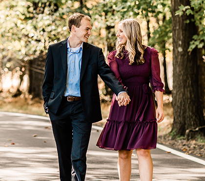 Henne Engagement Ring Couple Avri & Zach Holding Hands and Walking Outdoors