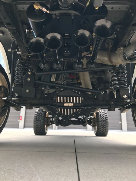 Front undercarriage four black Shocker XL train horn trumpets Rough Country steering stabilizer John's 2014 Dodge Ram 2500 HornBlasters featured customer install gallery photo 2
