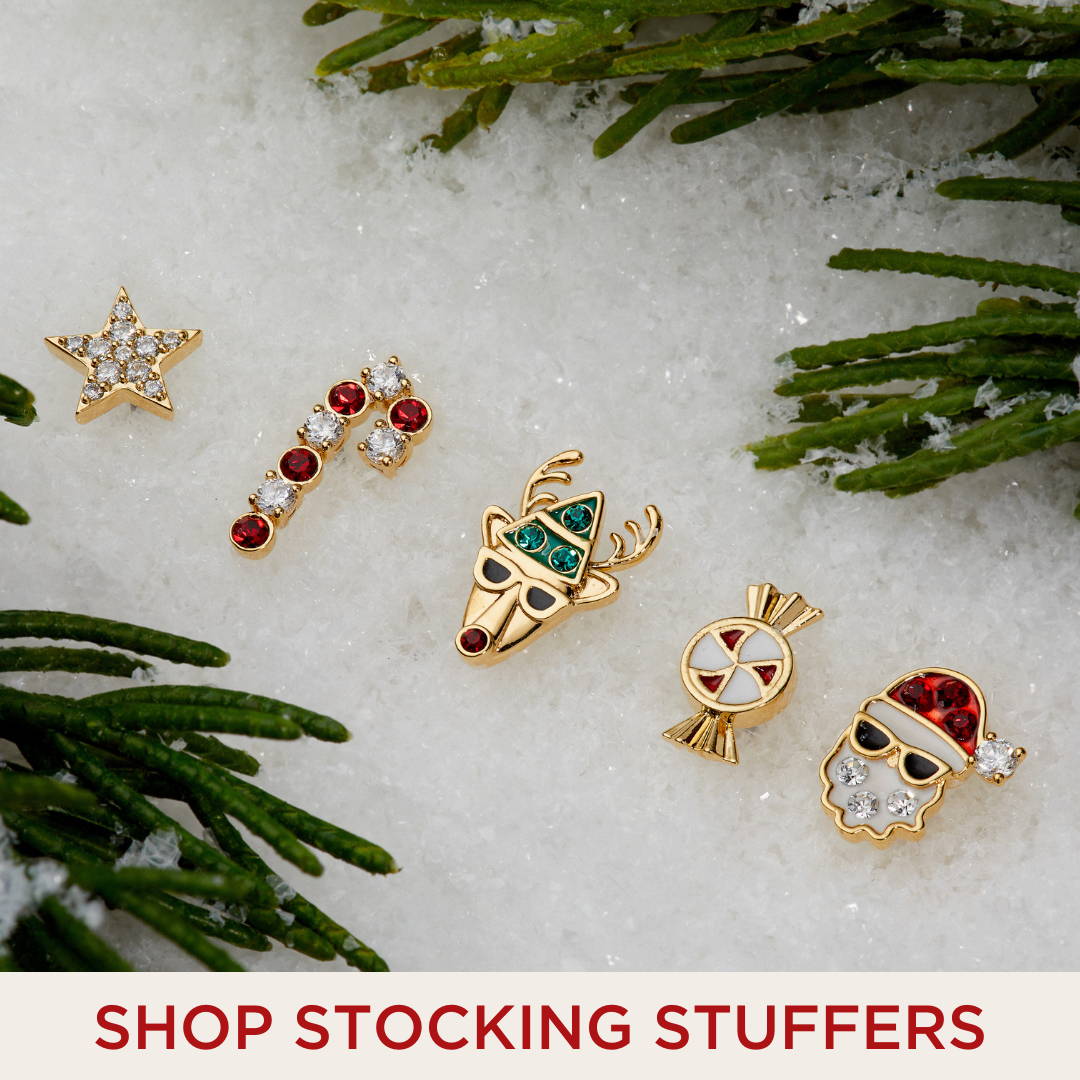 SHOP STOCKING STUFFERS. Image of star, candy cane, reindeer, peppermint, and santa clause stud earrings. 