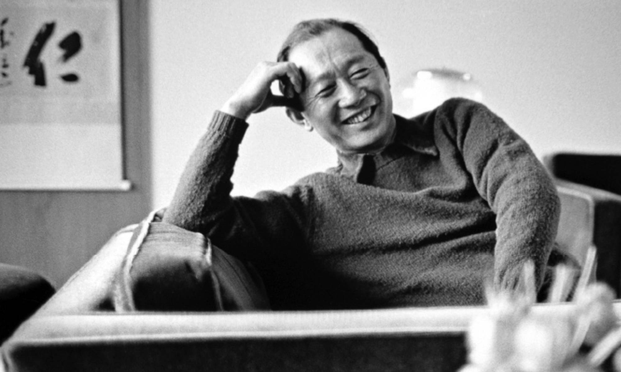 Yama, the iconic new formalism architect, laughing on mid century style couch
