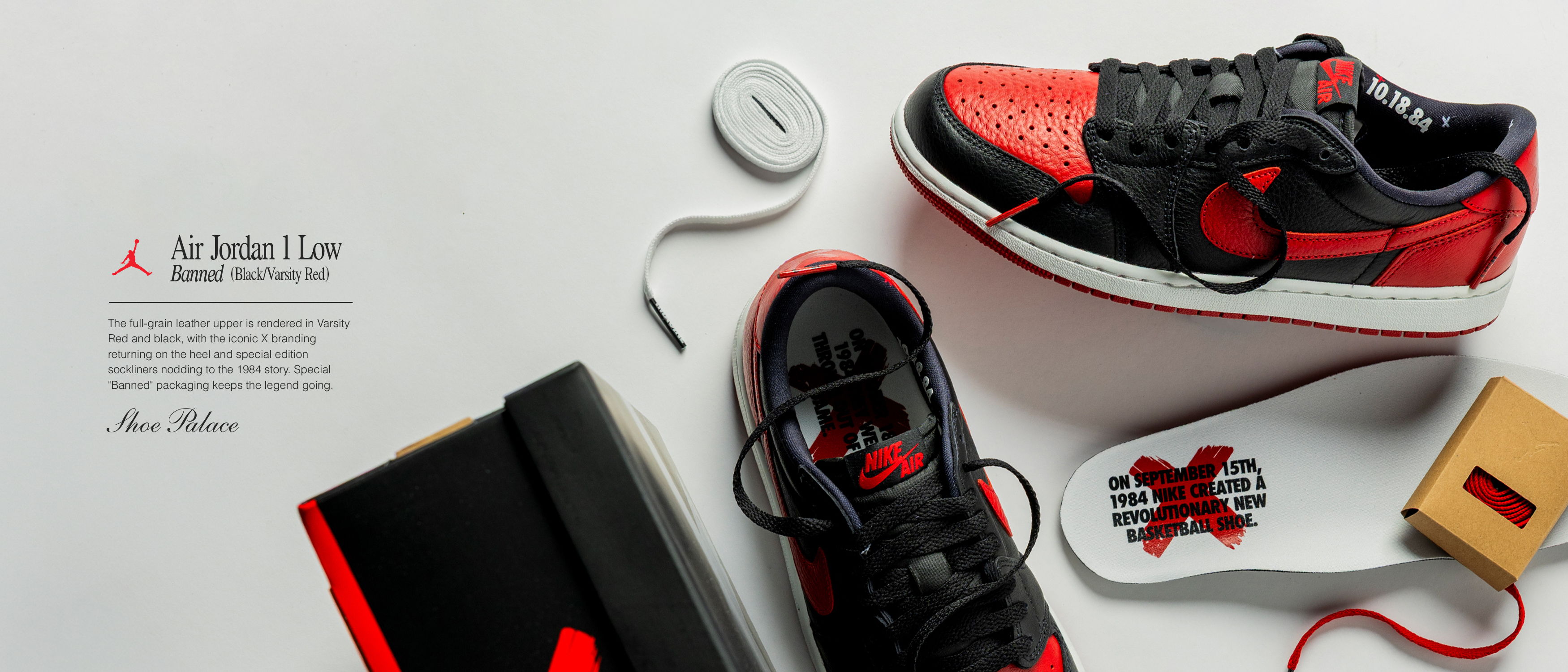 Red and black sneakers displayed with laces and packaging on a white background.