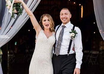 Happy bride and groom in black and white paisley