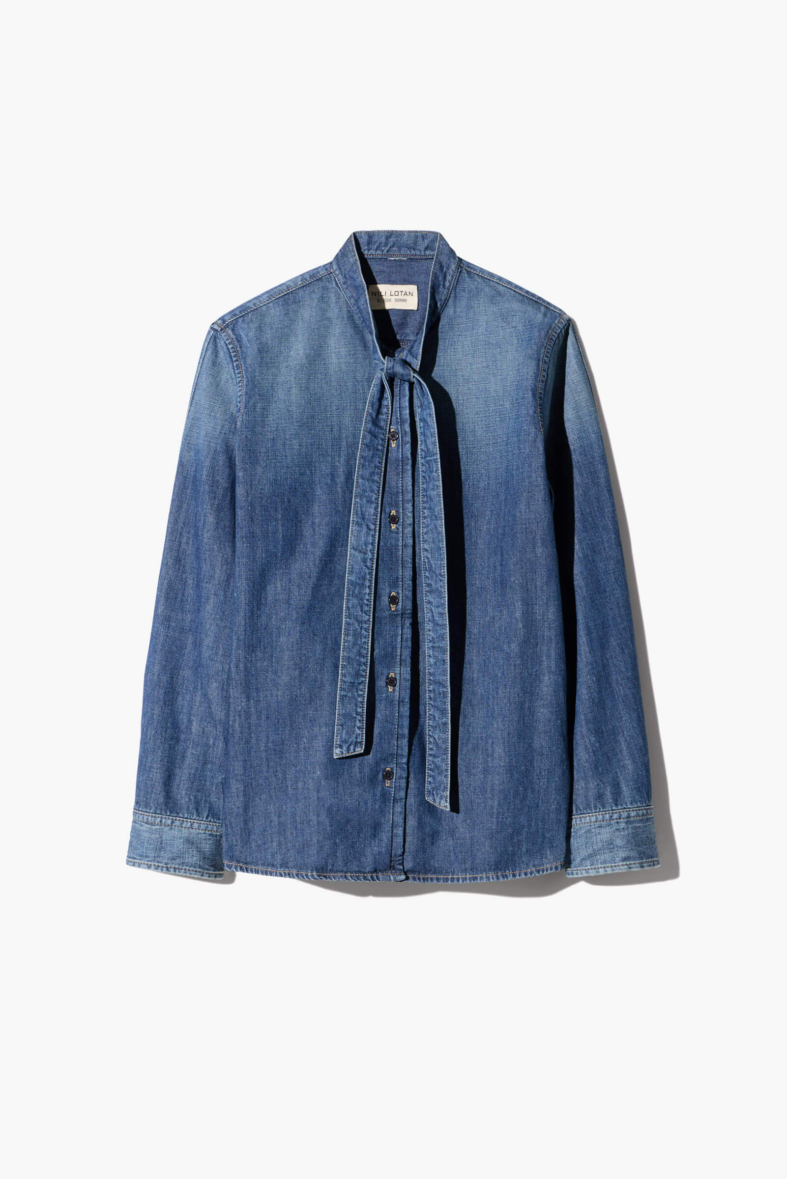 Denim shirt with a bow tie collar and long sleeves.