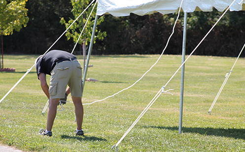 man installing tent ropes