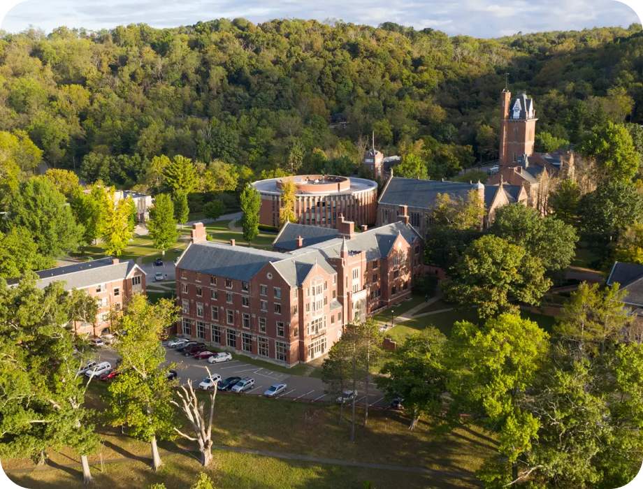 Aerial view of a college campus surrounded by trees.