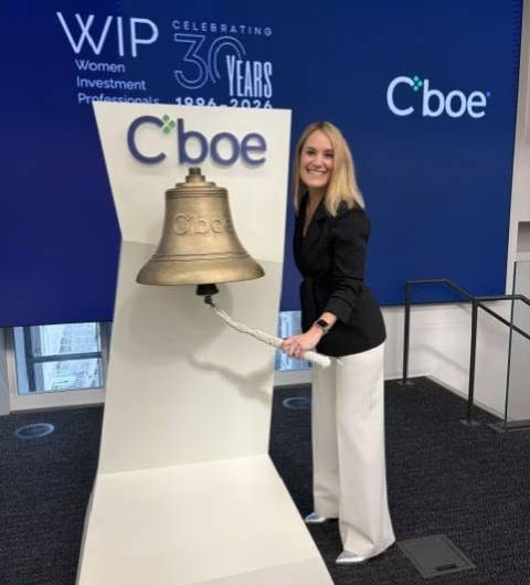 Person ringing a bell at a celebratory event for Cboe.