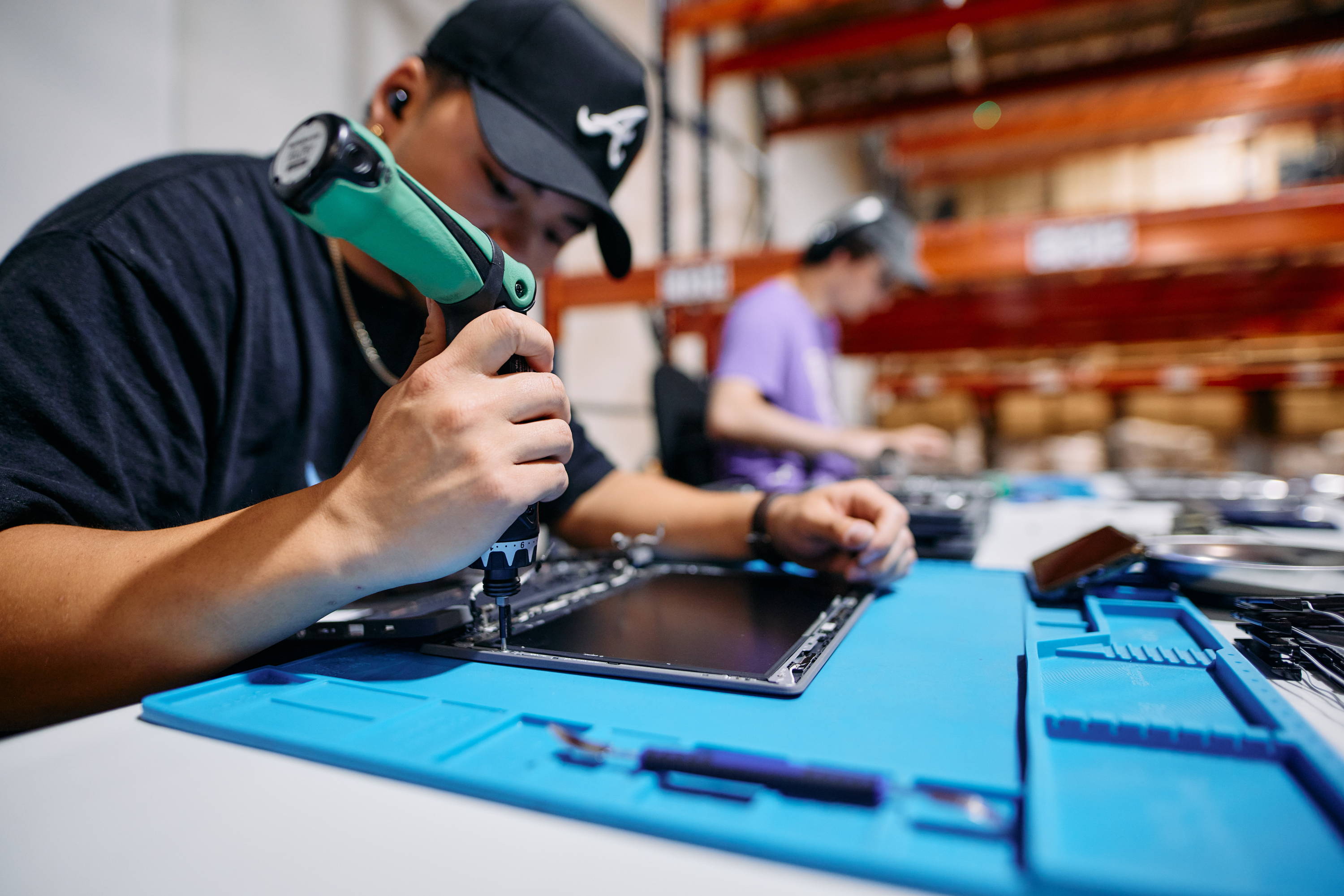 Repair technician fixing a Chromebook